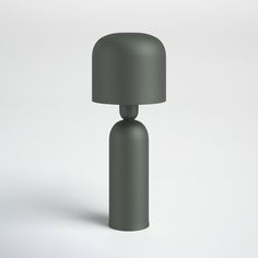 a gray table lamp sitting on top of a white floor