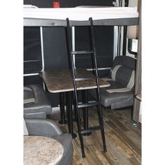 the bunk bed is next to two chairs and a table