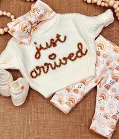 **PLEASE NOTE:  Set includes handcrafted knot head wrap, sweater, pants and booties.  Size is NEWBORN and fits infants 6-10 lbs. Creamy white cable knit booties have button closure; size is 0-3 months. Lusciously soft CREAMY WHITE sweater has a shaker stitch pattern; oversized so that little love can wear for months to come.  Super cute for birth announcement photos!  "just arrived" in golden amber yarn is HAND embroidered.  Interface fabric covers yarn backing so won't irritate baby's skin. Organic cotton knit knot head wrap and pants in sweet boho sun and rainbow design.  Pants have elastic free yoga style comfort waistband; cuffs extend wear.  Knot head wrap is adjustable. Care card included with order. Baby Going Home Outfit, Rainbow Pants, Sweater Sets, Girl Coming Home Outfit, Boho Sun, Girls Coming Home Outfit, Going Home Outfit, Knitted Booties