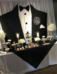 a black and white tuxedo themed dessert table