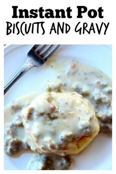 a white plate topped with biscuits and gravy next to a knife and fork