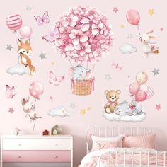 a child's bedroom with pink wallpaper and balloons