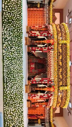 an elaborately decorated building in the middle of a room with flowers growing out of it