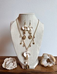 Necklace and Earrings Set:  Enchanted with the intention of confindence and abundance. This set includes three cleansed natural shells that are wrapped with Gold Plated or Sterling Silver Wire.  Each order contains a goodie bag!✨ MAY TARNISH if cared for inproperly. (Instruction sheet with take care instructions will be included in order!) White Spiritual Jewelry With Matching Earrings, Bohemian White Jewelry Sets For Gift, Bohemian White Jewelry Sets As Gift, Gold Dangle Jewelry With Unique Variations, Nature-inspired Gold Jewelry With Unique Variations, White Teardrop Nature-inspired Jewelry, Handmade White Ocean-inspired Jewelry, White Spiritual Dangle Jewelry, Ocean-inspired White Jewelry With Matching Earrings