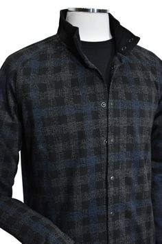 Introducing the Marcello Terrio Button Front Shacket, the perfect combination of style and functionality. This shirt jacket features a classic mock collar and snap enclosure, along with open sleeve cuffs and a waist band for a comfortable fit. The rich black base color is accented with a charcoal plaid pattern and a pop of royal blue. A mix of cotton, viscose and microfiber for a soft, light weight garment. Tubular cuffs and waist band add contemporary cool style. The model is perfect for a slim Winter Flannel Shirt With Snap Buttons, Winter Shirt With Spread Collar And Button Closure, Winter Shirt With Button Closure And Spread Collar, Stand Collar Shirt With Button Closure For Work, Stand Collar Shirt With Buttons For Fall, Winter Shirt With Button Closure And Lapel Collar, Fall Shirt With Stand Collar And Buttons, Classic Winter Shirt With Snap Buttons, Fall Shirt With Hidden Button Closure