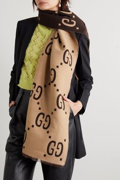 Gucci's scarf is woven from a sumptuous blend of wool and silk so it feels really soft and smooth against your skin. It's patterned with an exaggerated version of the house's 'GG' emblem in earthy brown and beige hues, which will go with so many coats and knits. Spritz it with cedar spray occasionally to deter moths. Elegant Gucci Silk Scarves, Elegant Gucci Silk Scarf, Designer Gucci Silk Scarves, Luxury Gucci Scarves For Fall, Luxury Gucci Silk Scarves, Designer Wool Scarves For Fall, Luxury Gucci Scarf For Winter, Luxury Gucci Scarves For Winter, Gucci Luxury Winter Scarves