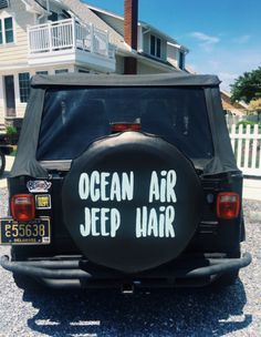 an ocean air jeep parked in front of a house with the words ocean air jeep written on it