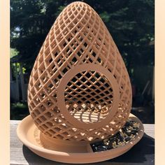 an egg shaped sculpture sitting on top of a plate