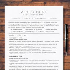 a professional resume is shown on top of a wooden table with a pen and paper