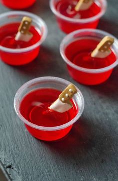 red cups with toothpicks in them sitting on a table