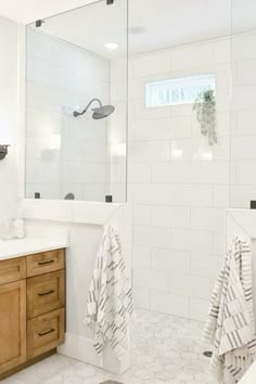 a bathroom with white tile and wooden cabinets