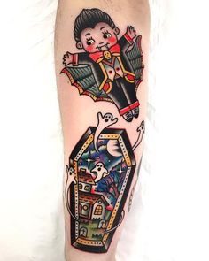 a person with a tattoo on their leg that has an image of a boy in a box