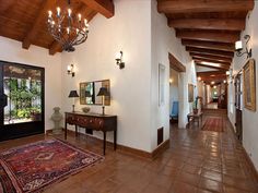 the hallway is clean and ready for guests to use it as an entrance way in this home