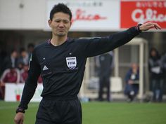 a soccer player holding his arm out to the side