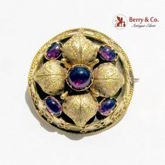 Antique Ornate Brooch Amethyst Cabochons, Foliate Decorations, Tiny Applied Wire Patterns & Rim, Closed Back 14K Yellow Gold c. 1870.  This spectacular brooch is 1" in diameter and weighs 5.4 grams.  [nb1095] Ceremonial Gold Cabochon Brooches, Purple Victorian Wedding Brooches, Wire Patterns, Antique Yellow Gold Brooches With Gemstone, Luxury Antique Cabochon Brooches, Antique Gold Brooch With Gemstone, Victorian Yellow Gold Brooches With Gemstone, Ornate Gold Cabochon Brooches, Victorian Multi-stone Wedding Brooches