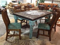 a table and chairs in a room with zebra rugs