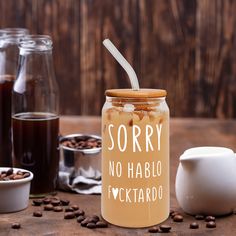 there is a jar with some liquid in it and coffee beans on the table next to it