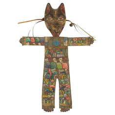 a wooden statue with an animal head on it's body and two arrows in its mouth