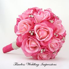 a bridal bouquet with pink flowers and pearls on the end is shown in front of a white background