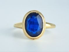 Lovely antique large blue sapphire ring in 10K yellow gold by the Plainville Stock Company of Victorian era Massachusetts. This pretty ring features a lovely oval sapphire set within a classic Victorian bezel mount. The stone appears to be original to the ring. The top of the ring measures 11.8mm north to south, and the sapphire measures 9x7mm. The entire ring is in excellent condition and bears the PSCO makers mark. Ring size 5 3/4 and easily sized up or down several sizes.  Please allow two we Classic Oval Cabochon Sapphire Ring With Bezel Setting, Classic Sapphire Ring With Oval Cabochon Bezel Setting, Classic 14k Gold Sapphire Oval Cabochon Ring, Classic Yellow Gold Sapphire Ring Oval Cabochon, Oval Faceted Sapphire Ring Fine Jewelry, Classic Sapphire Ring Oval Cabochon, Classic Sapphire Oval Signet Ring, Classic Oval Sapphire Signet Ring, Elegant Oval Faceted Sapphire Ring