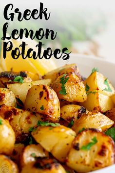 a white bowl filled with cooked greek lemon potatoes