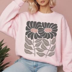 Retro Flower Sweatshirt, Boho Wildflower Floral Minimalist Sweater Sun Flower Print Crewneck Trendy Sweatshirt Garden Lover Gardening Gifts Ideal for any situation, a unisex heavy blend crewneck sweatshirt is pure comfort. These garments are made from polyester and cotton. This combination helps designs come out looking fresh and beautiful. The collar is ribbed knit, so it retains its shape even after washing. There are no itchy side seams on these sweaters. This design is also available on a un Minimalist Sweater, Floral Minimalist, Boho Wildflower, Gardening Gifts, Flower Sweatshirt, Retro Flowers, Oversized Sweatshirt, Flower Print, Cut And Style