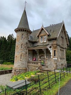 an old stone house with a turret and steeple