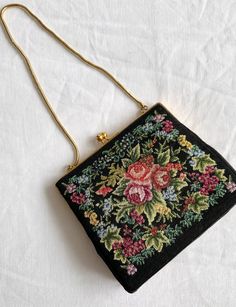 🤍VINTAGE SMALL BLACK ROSE TAPESTRY HANDHELD BAG🤍 This beautiful embroidered floral bag will be a talking point at your next event, party or wedding. **WELCOME TO SEASONALLY DRESSED** BRAND: Unknowm  Measurements: Width: 13.5cms Length 12.5cms Depth: 3cms ⭐️ ITEM DESCRIPTION ⭐️ A stunning little vintage evening bag.  The bag has a black background with embroidered tapestry floral rose detail and gold (coloured) metal clasp, the floral design is on both sides.The bag has a gold coloured chain.  The chain is designed to be held in the hand. 🧵CONDITION🧵~ In excellent vintage condition and ready to wear 👗 LOVE THIS BAG? YOU MAY ALSO LIKE👗  🖤 🖤 🛒SHOP WITH US  🛒  ETSY: seasonallydressed.etsy.com INSTAGRAM: https://www.Instagram.com/seasonally_dressed 🌎 🇬🇧 📦FREE SHIPPING  🌎  There i Vintage Embroidered Shoulder Bag For Everyday Use, Vintage Floral Embroidery Bags For Formal Occasions, Vintage Floral Embroidered Bag For Formal Occasions, Formal Embroidered Tapestry Bag, Embroidered Tapestry Bag In Rectangular Shape, Vintage Embroidered Formal Bags, Vintage Bags With Floral Embroidery For Daily Use, Vintage Embroidered Bag For Daily Use, Vintage Embroidered Shoulder Bag