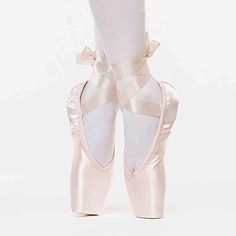 the feet of a ballerina in pink ballet shoes