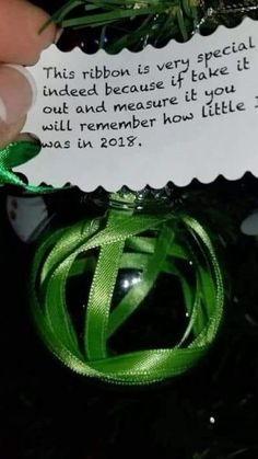 someone is holding a christmas ornament with a note attached to it that says, this ribbon is very special