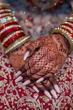 a woman's hands with hennap and bracelets