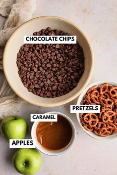 chocolate chips, pretzels, apples, and caramel are in bowls on the table