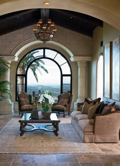 a living room filled with furniture and a large window