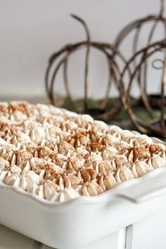 a casserole dish with white frosting and sprinkles on top