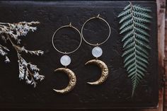 "Boho beauties made from floral brass moons adorned with aura quartz gemstone beads and hung on gold plated brass hoops. They measure approximately 3\" long." Bohemian Hoop Earrings With Moon Charm Dangle, Bohemian Dangle Hoop Earrings With Moon Charm, Gold Wire Wrapped Hoop Earrings For Festivals, Handmade Moon Shaped Bohemian Hoop Earrings, Bohemian Gold Hoop Earrings With Moon Charm, Bohemian 14k Gold Filled Hoop Earrings, Bohemian Hoop Earrings With Moon Charm, Bohemian Crescent Hoop Earrings With Moon Charm, Boho Beauty