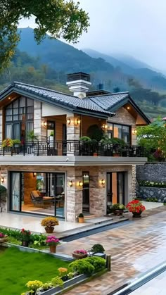 a large house sitting on top of a lush green field next to a hillside covered in trees