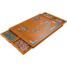 three pieces of puzzle sitting on top of a wooden tray with blue and white designs