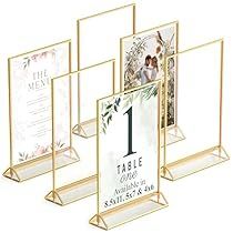 three clear acrylic frames with wedding photos on the front and one in the back