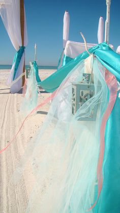 the beach is decorated with blue and white linens