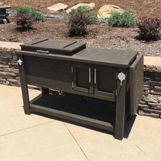 an outdoor entertainment center is shown in the middle of a garden with rocks and grass