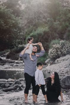 a man and two children are playing in the water