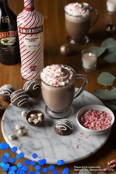 hot chocolate drink with marshmallows and peppermint on marble serving platter