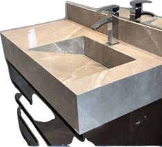 a bathroom sink that is made out of marble and has a black faucet