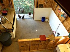 two chickens are standing in the corner of a room that has been built into the wall