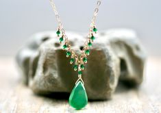 "Beautiful green onyx pendant hangs on a 14KT gold filled chain with tiny 2mm emerald green zircon gemstones wire wrapped in a fringe cascade.  This is a petite style necklace.  Adjustable length 16\"-18\".  Well made and beautiful!  Matching earrings sold separately. Necklace length: 16\"-18\" Pendant size: 3/4\" L Zircon size: 2mm Please note that pictures are taken up close to show detail.  Therefore, this necklace looks larger in the pictures than it is in person. Due to monitor settings and Green Drop Necklaces In Fine Jewelry Style, Green Briolette Necklace In Fine Jewelry Style, Green Drop Emerald Necklace For May Birthstone, Elegant Green Onyx Pendant Necklace, Green Briolette Necklace Fine Jewelry, Green Drop-shape Birthstone Necklace, Emerald Drop Gemstone Necklace, Green Emerald Drop Necklace, Elegant Dangle Necklaces For May Birthstone