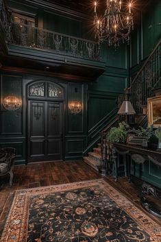 an ornately decorated entryway with chandelier and green walls, wood flooring