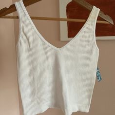 Nwt Free People Size M/L White Never Worn 50% Rayon, 45% Nylon, 5% Spandex White Seamless Crop Top For Spring, Spring White Seamless Crop Top, White Seamless Crop Top For Day Out, White Sleeveless Bra-friendly Tank Top, White Seamless Knit Crop Top, White Sleeveless Bra-friendly Camisole, Free People Ribbed Tank, White Compressive Seamless Tank Top, White Stretch V-neck Camisole