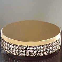 a gold and silver box sitting on top of a wooden table