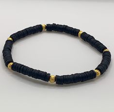 Heishi Black and Gold Bead Bracelet, Durable and unique!  Perfect for stacking or wearing alone. Gold Bead Bracelet, Clay Bead Bracelet, Black Bead Bracelet, Flat Bead Bracelet, Stacking Bead Bracelet Embrace the effortless style of our Heishi Bead Bracelet! Made with lightweight beads, it's perfect for stacking and adding a cute touch to any outfit. Elevate your look and get ready to feel confident and trendy. Bracelet: 8 inches long, made with polymer clay beads and gold beads, double strand stretch bracelet. Adjustable Rondelle Bracelets With Spacer Beads, Black Beaded Bracelets With Large Beads For Beach, Black Heishi Beads For Beach, Black Heishi Beads Beaded Bracelets, Black Heishi Beads Bracelet, Black Heishi Beads Bracelet As Gift, Black 8mm Beads Beach Jewelry, Beach Jewelry With Black Heishi Beads, Black Beach Jewelry With 8mm Beads