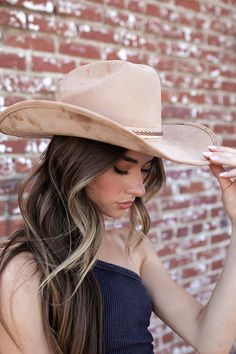 A timeless and on trend cowboy hat that’s crafted in a ivory faux suede with a coordinating band wrapped around. Meet the El Dorado Cowboy Hat. The crown is stiffened and shaped into a clean and ridged design. Hand made by artisans, incredible quality, faux suede, lined with satin underneath. The best part? It's super structured with an elastic band on the inside that is so comfortable! No hat sizing - OSFM (one size fits most) THE HAT:-Cowboy style hat, faux suede-Stiff brim with elastic hat ba Cream Wide Brim Felt Hat For Rodeo, Western Cream Fedora Felt Hat, Wide Brim Beige Felt Hat For Rodeo, Cream Western Fedora Felt Hat, Western Cream Felt Hat With Flat Brim, Beige Fitted Felt Hat For Rodeo, Fitted Beige Felt Hat For Rodeo, Beige Western Felt Hat With Flat Brim, Adjustable Beige Felt Hat For Ranch